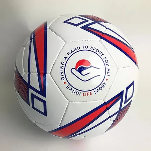 كرة قدم بيضاء كبيرة عليها علامات حمراء وزرقاء ومكتوب عليها "Giving a Hand to Sport for All".