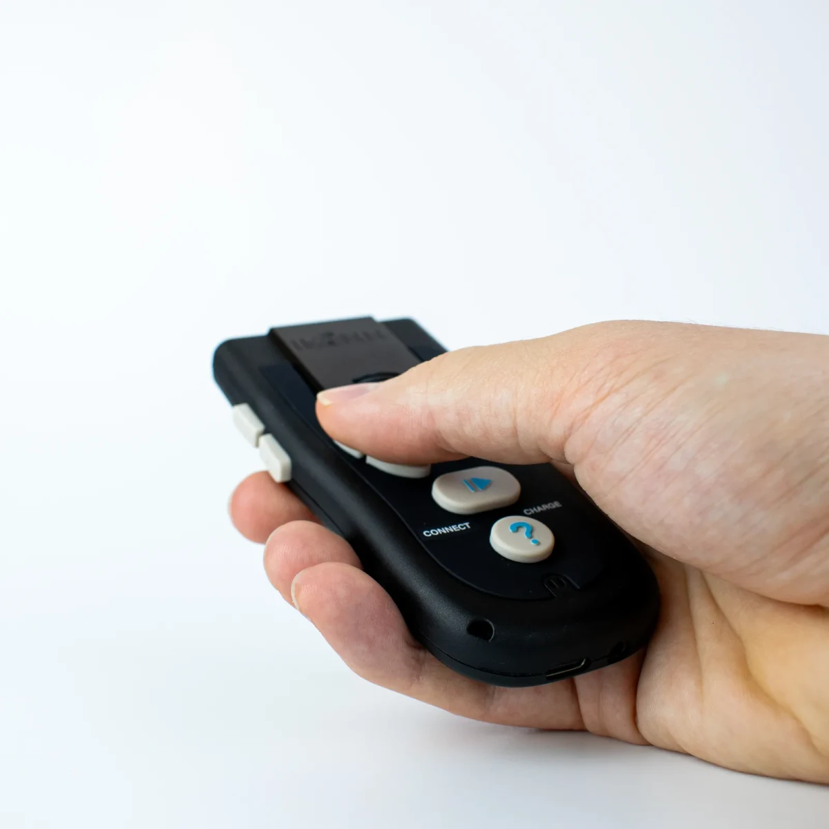 The Controller resting in an open palm, thumb on the buttons