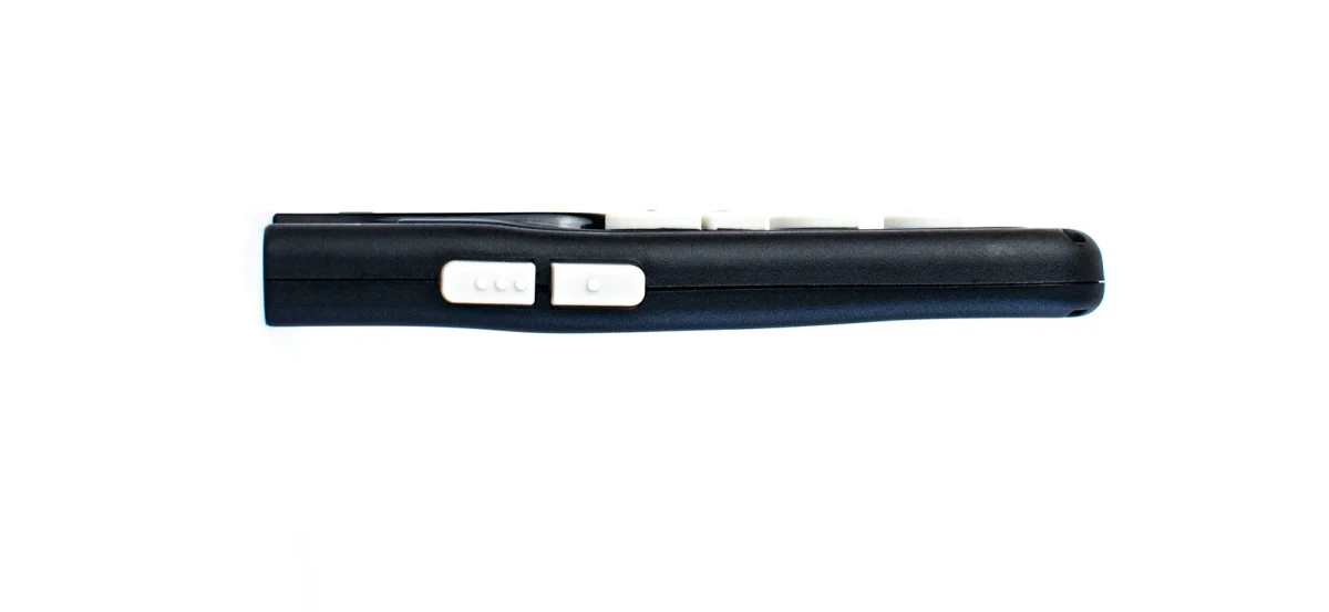 Left edge of the Controller, two slide switches with three raised dots and one raised dot