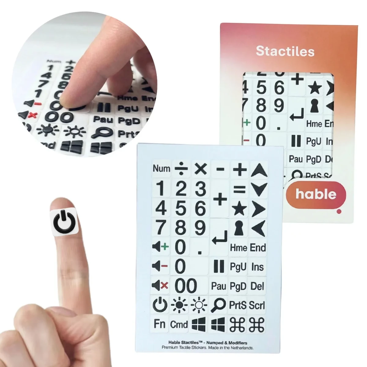 مجموعة ملصقات Hable Stactiles للوحة الأرقام والمفاتيح الإضافية: ورقة بيضاء تحتوي على ملصقات سوداء على خلفية بيضاء تشمل لوحة الأرقام، رموز الرياضيات، مفاتيح الصوت والسطوع والطاقة والتنقل مثل Home وEnd وPage Up وPage Down، معروضة مع علبتها البرتقالية. طرف إصبع يمسك ملصق زر الطاقة وصورة مقربة تظهر أصابع تتحسس المفاتيح.