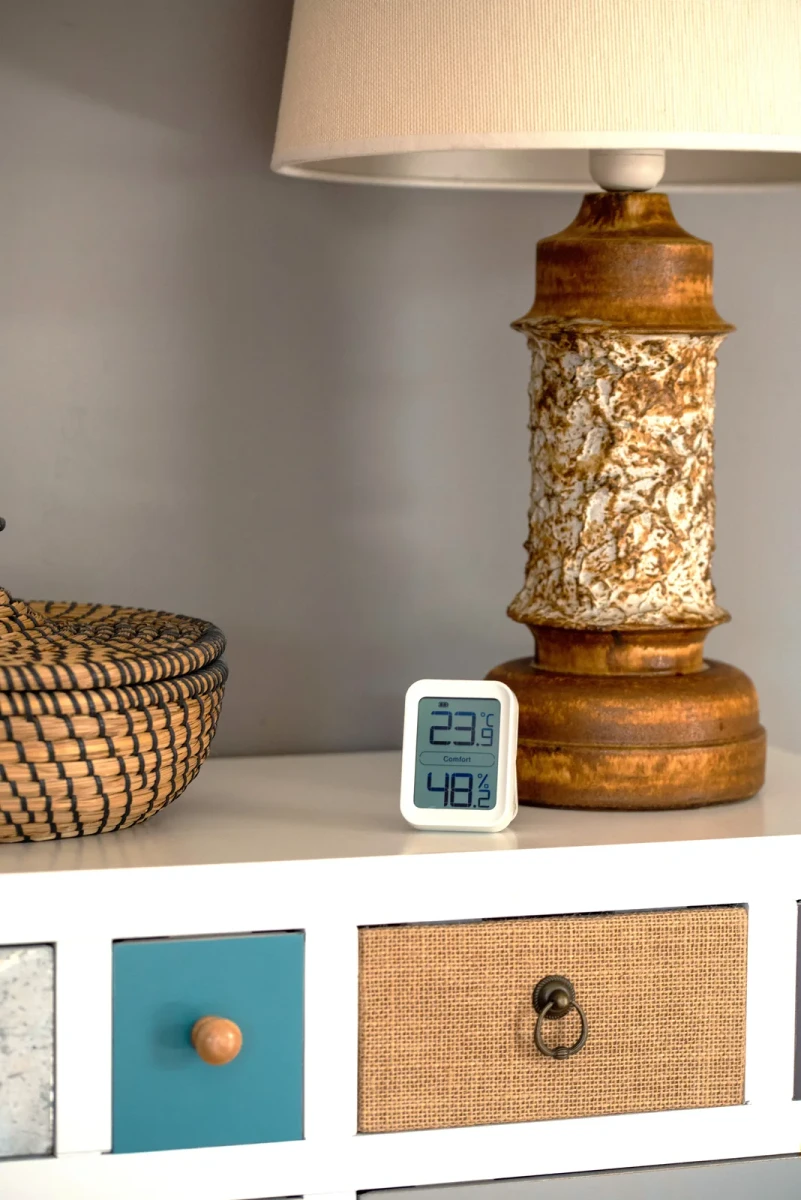 The TI-1 standing on a white console beside a ceramic table lamp