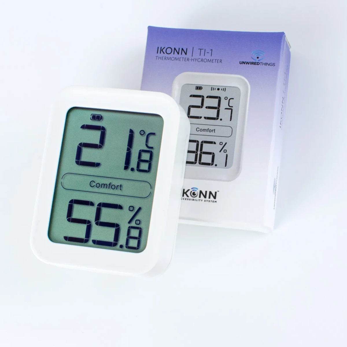 The TI-1 reading 21.8 Celsius leaning against its violet retail box